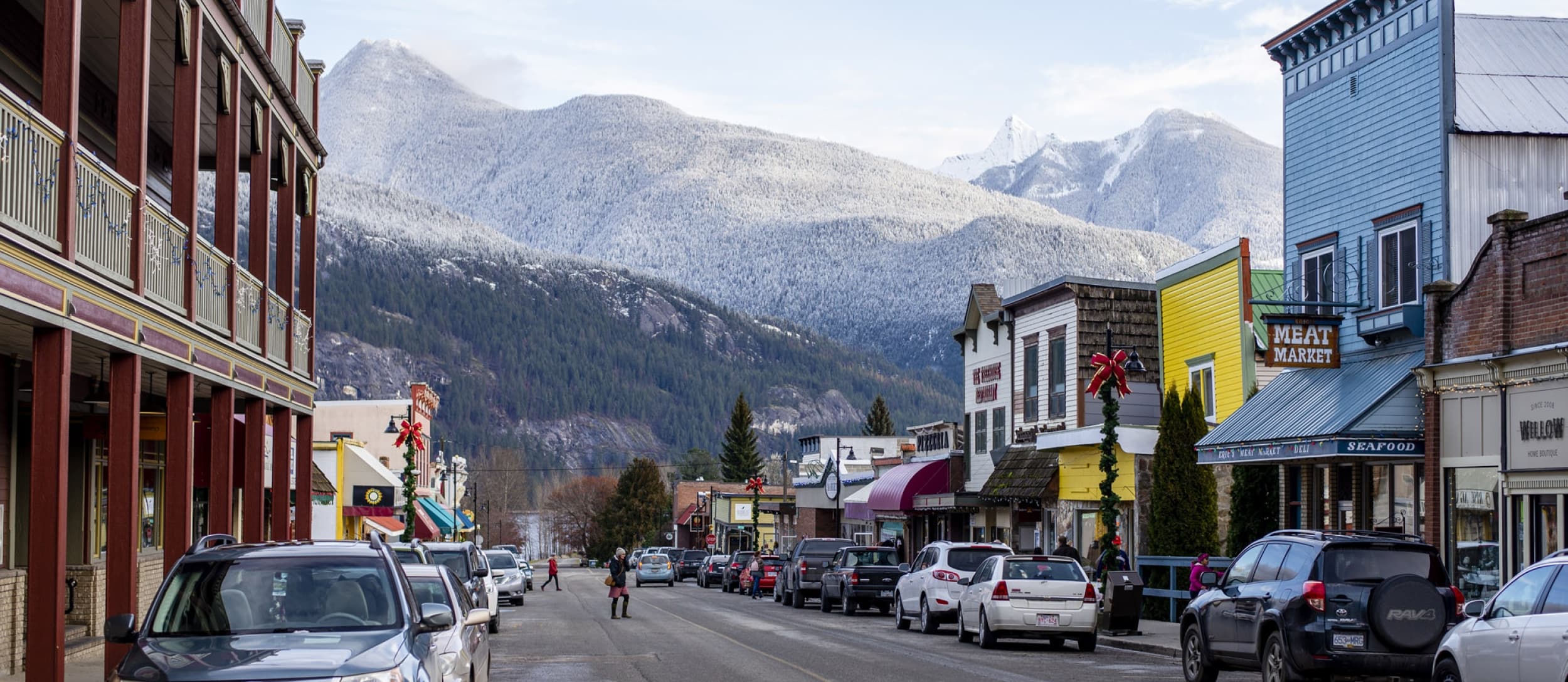 The historic main street of Kaslo, BC with snowy peaks behind
